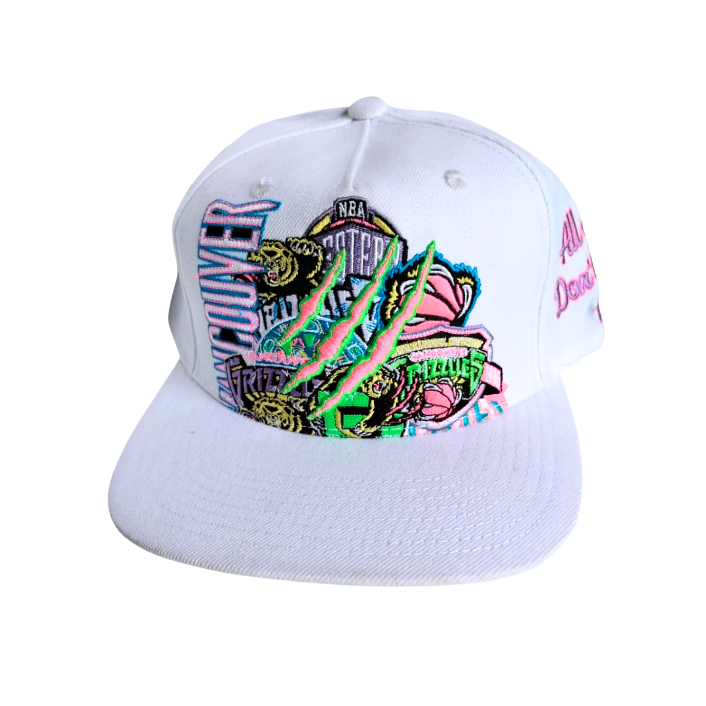 Close-up of a white cap adorned with a vibrant multicolored design, showcasing bold patterns and bright hues that stand out against the white background